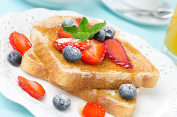 crispy toast with honey, fresh berries, cup of coffee and juice