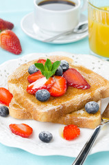 crispy toast with honey, fresh strawberries and blueberries