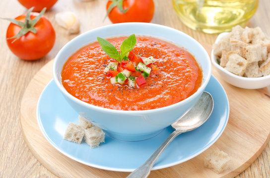 Fototapeta cold tomato soup gazpacho with basil, croutons in a bowl