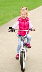 Fototapeta na wymiar Little girl with her bicycle