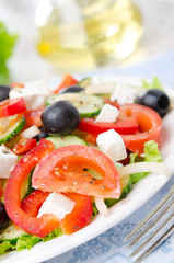 Greek salad with feta cheese, olives and vegetables, close-up