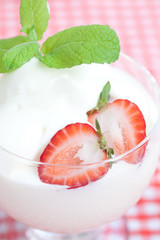 ice cream,strawberry with mint in a glass bowl on plaid fabric