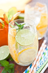 Fresh drink with orange, lemons and ice