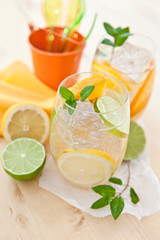Fresh drink with orange, lemons and ice