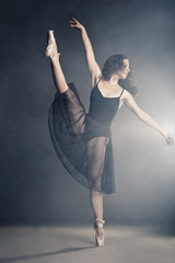 Modern style dancer posing on grey background