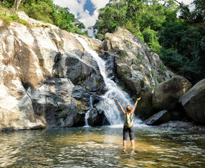Female hiker looking at waterfall