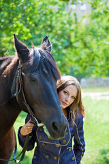 Obraz premium Portrait of a young girl with a horse.