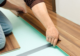 Man laying parquet in clean room