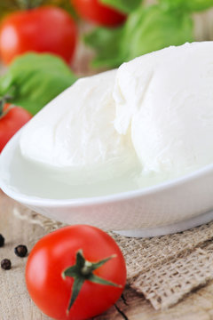 Fresh balls of mozzarella cheese with tomatoes and basil