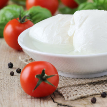Fresh balls of mozzarella cheese with tomatoes and basil