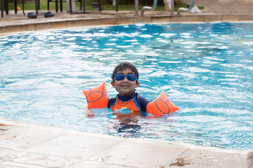 Child Enjoying Swimming in a Pool in Summer