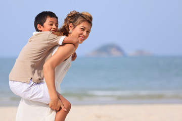 Mom and son play on beach
