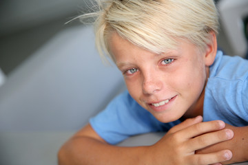 Portrait of young boy with blue eyes and shirt © goodluz