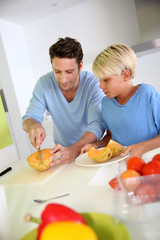 Obraz na płótnie Canvas Father and child preparing melon for dinner