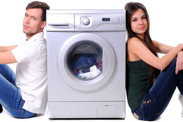 beautiful young couple with a washing machine