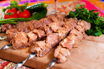 Raw kebab on wooden board