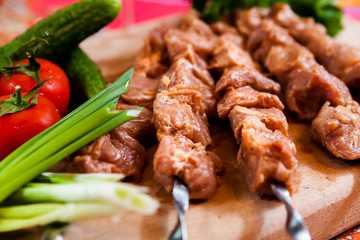 Raw kebab on wooden board