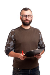 Young man writing on a clipboard