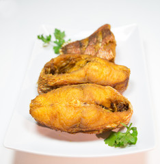 Portions of deep fried red snapper fish.