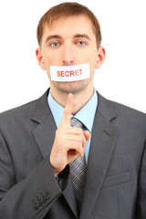 Young businessman with a band on his mouth isolated on white