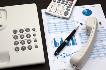 business report with telephone on a table