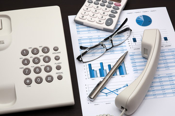 business report with telephone on a table