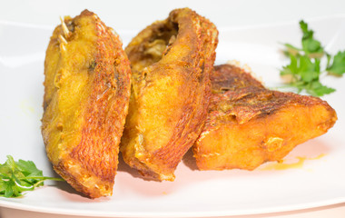 Portions of deep fried red snapper fish.