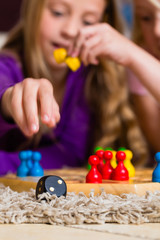 Family playing board game at home