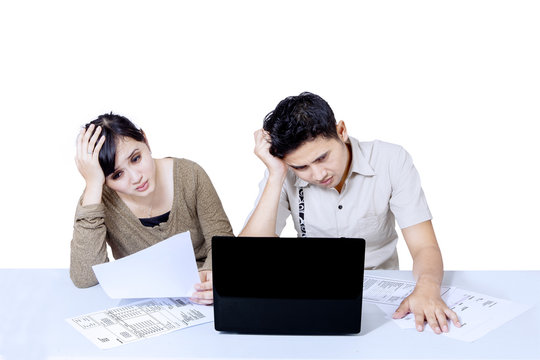 Stress couple paying bills online - isolated