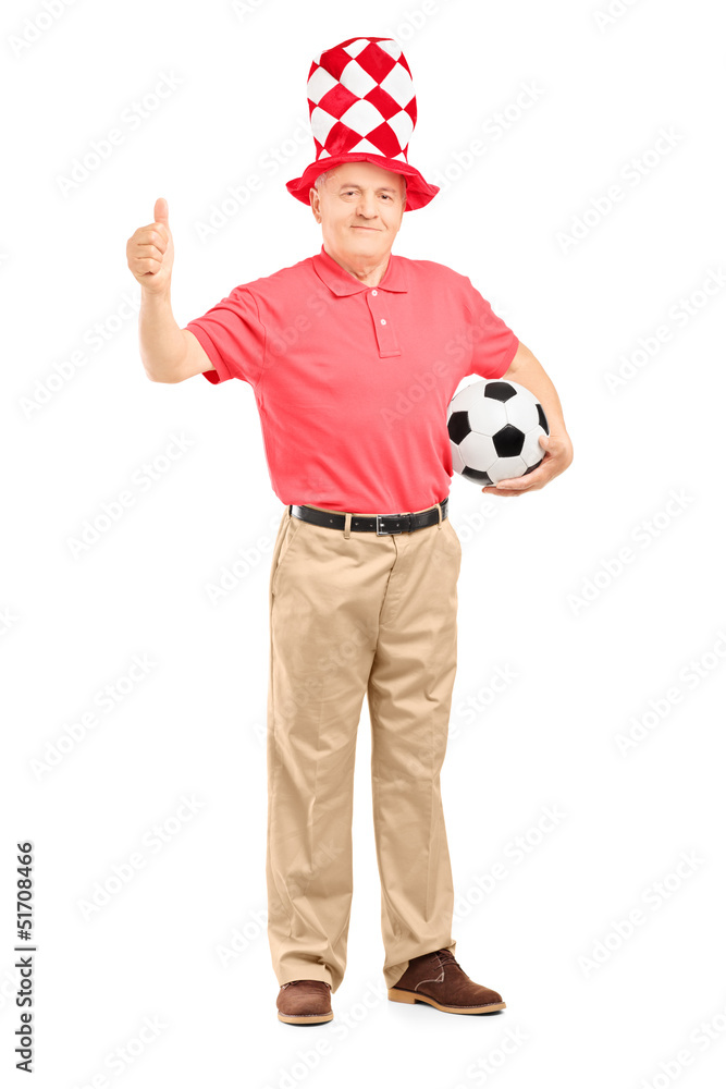 Poster Happy mature fan with hat holding a soccer ball and giving a thu