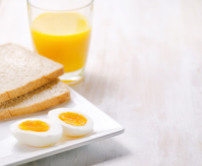 Boiled egg, toasts and orange juice.