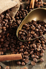Coffee in  sack and scoop on wooden table