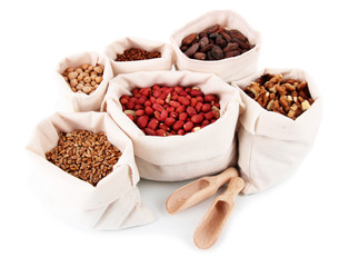 Different kinds of beans in sacks isolated on white