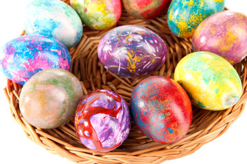Beautiful Easter eggs in wicker basket close-up