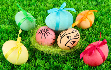 Fototapeta premium Colorful eastern eggs on grass background
