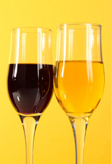 Wine in glasses  on yellow  background