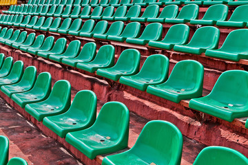 Fototapeta premium green plastic chairs on a football tribune