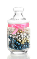 Glass jar containing various beads isolated on white