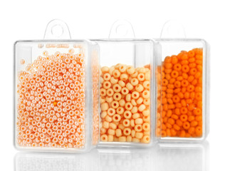 Colorful beads heap in boxes isolated on white