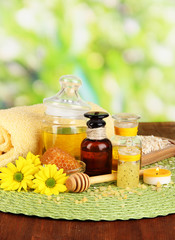 Fragrant honey spa with oils and honey on wooden table close-up