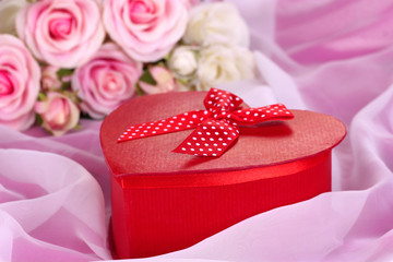 Beautiful gift on flowers background