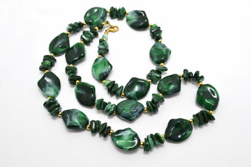 green beads lying on a white background