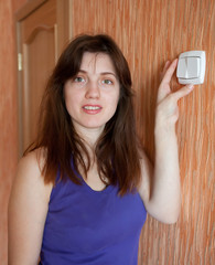  woman turning off the light switch