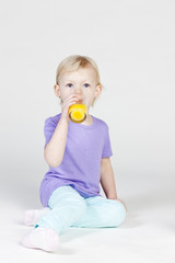little girl drinking orange juice