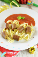 Würstchen aus Tofu, aufgefädelt auf Spaghetti