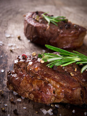 Delicious beef steaks on wooden table