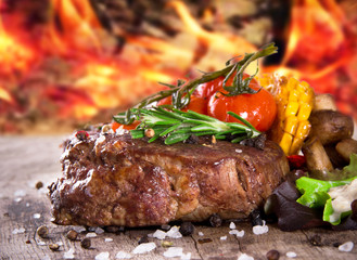 Delicious beef steak on wooden table