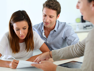 Couple signing real-estate contract