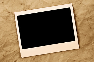 blank instant photo frame on an old paper background