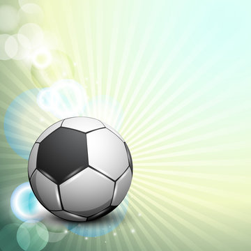 Shiny soccer ball on rays background and space for your message.